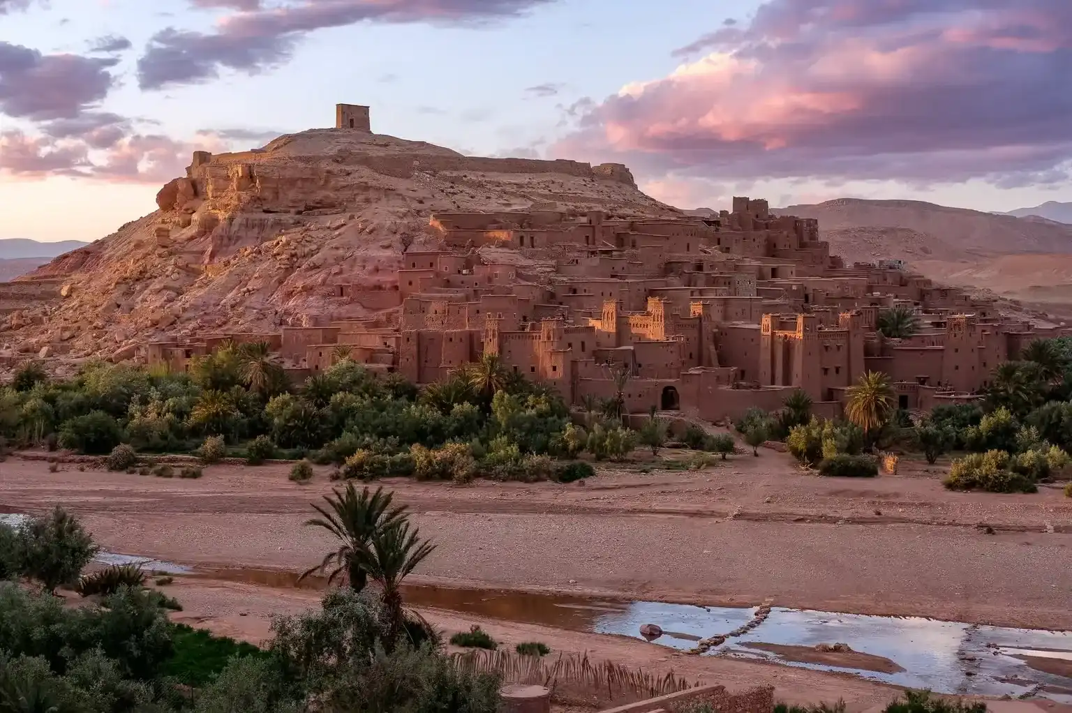 Le ksar d'Aït Ben Haddou au coucher du soleil sous des nuages roses